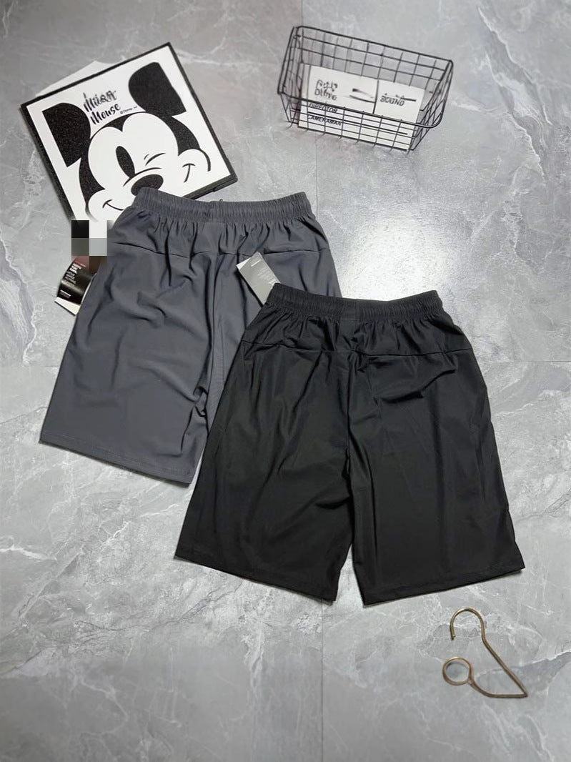 Black and gray athletic shorts with side zippers