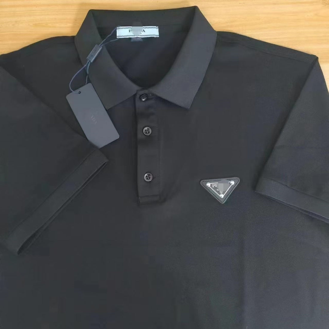 Black or white short-sleeve polo shirt with ribbed collar and half-placket