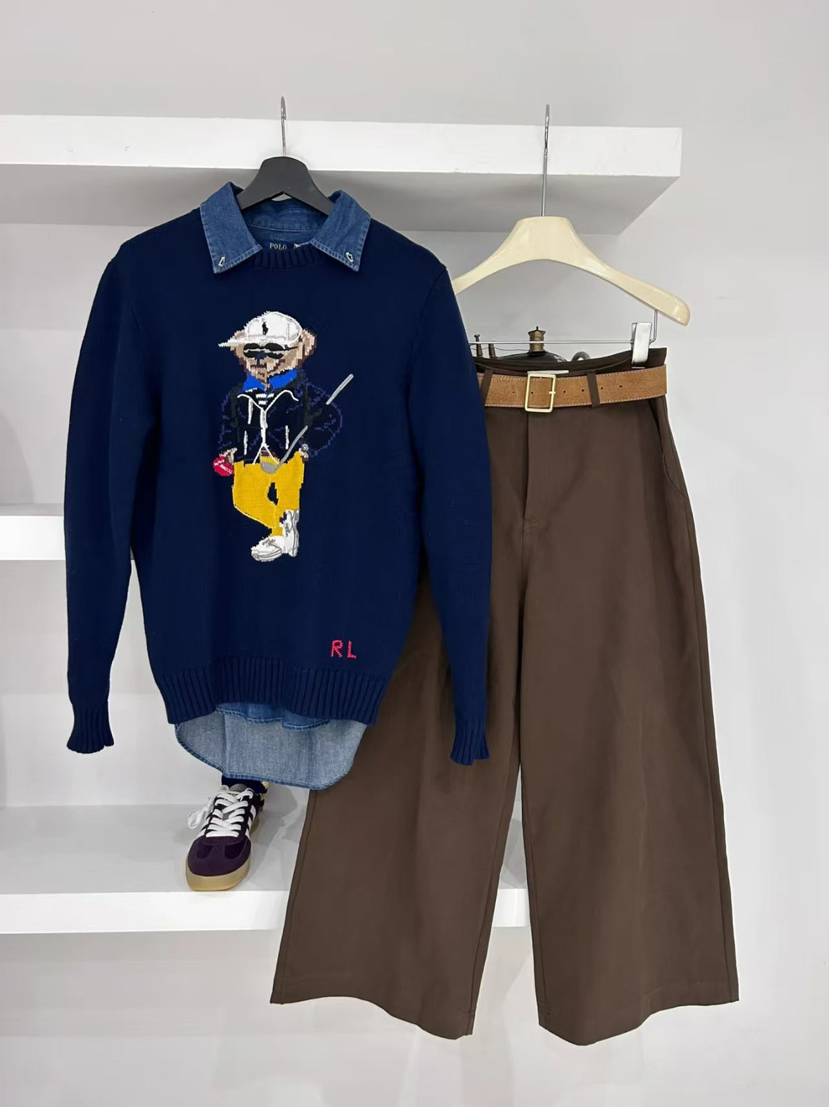 Navy crewneck sweater with embroidered bear holding golf club