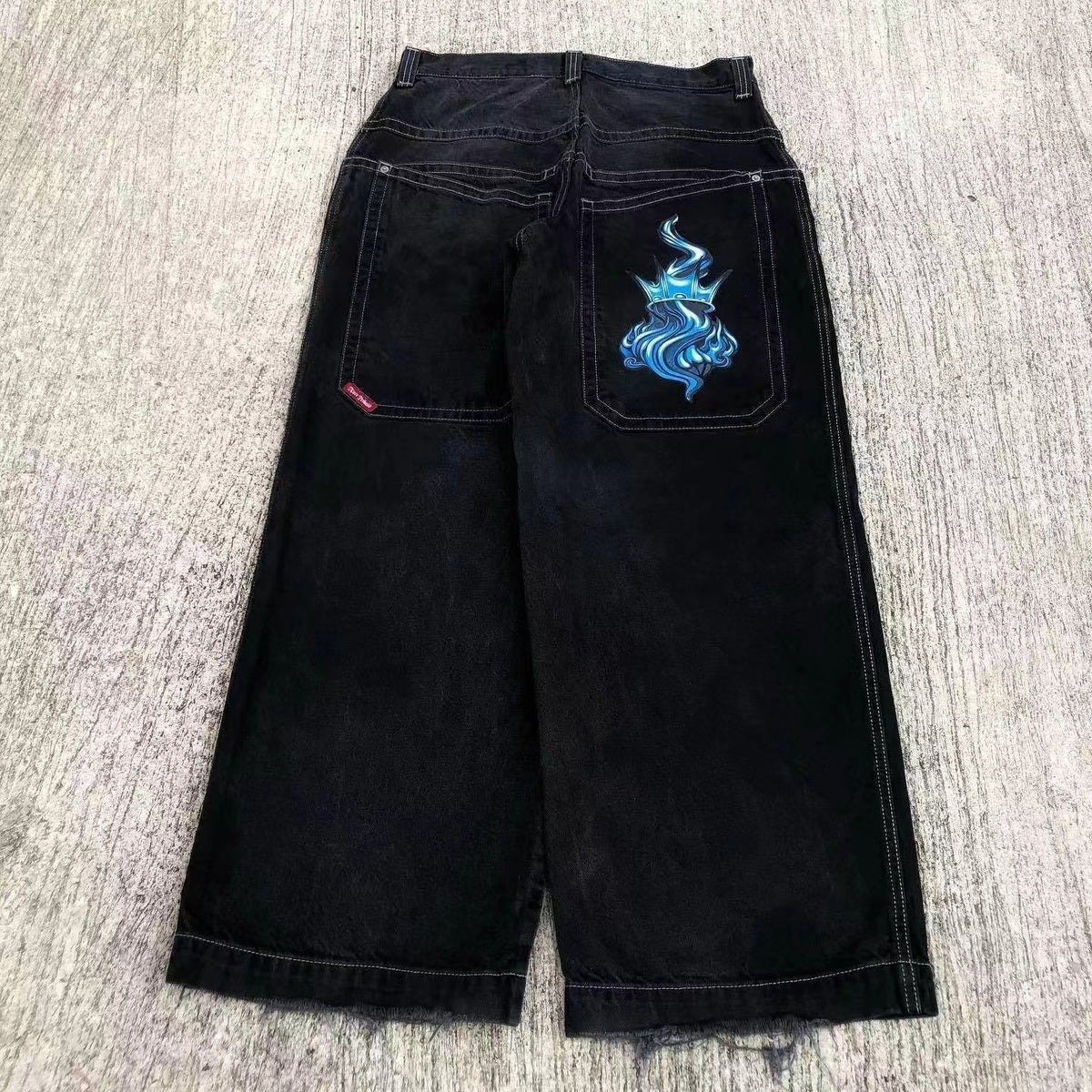 Baggy denim jeans with embroidered back pocket graphics
