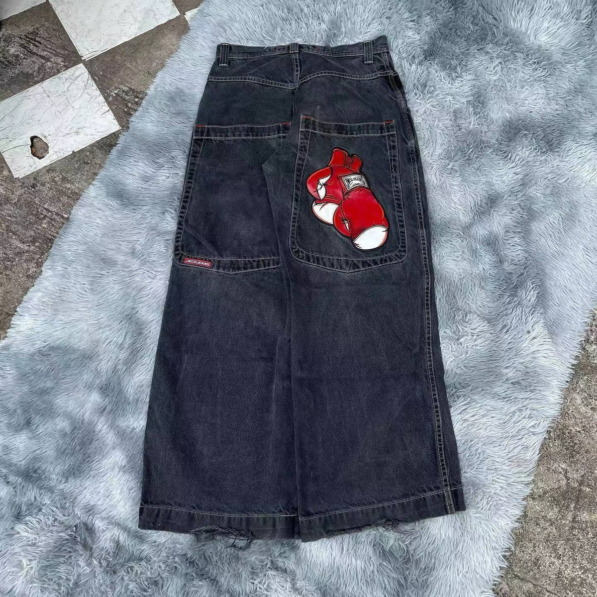 Baggy denim jeans with embroidered back pocket graphics