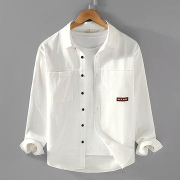 Beige long-sleeve cotton shirt with chest pockets and black buttons