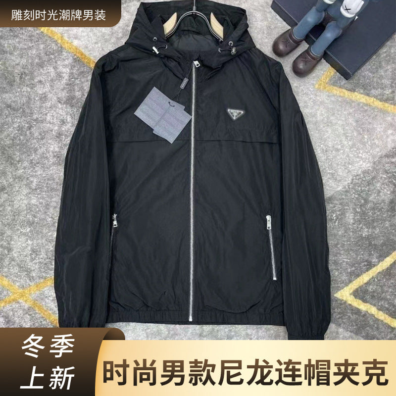 Black or gray hooded windbreaker jacket with zip pockets
