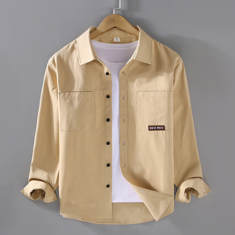 Beige long-sleeve cotton shirt with chest pockets and black buttons