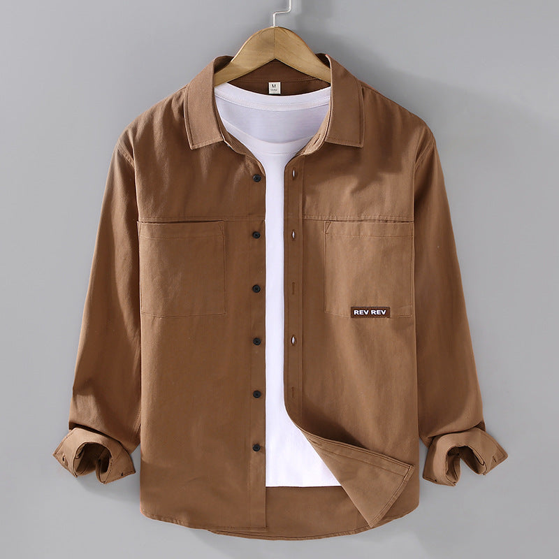Beige long-sleeve cotton shirt with chest pockets and black buttons