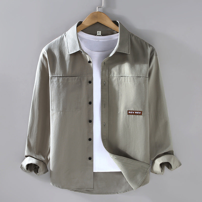 Beige long-sleeve cotton shirt with chest pockets and black buttons