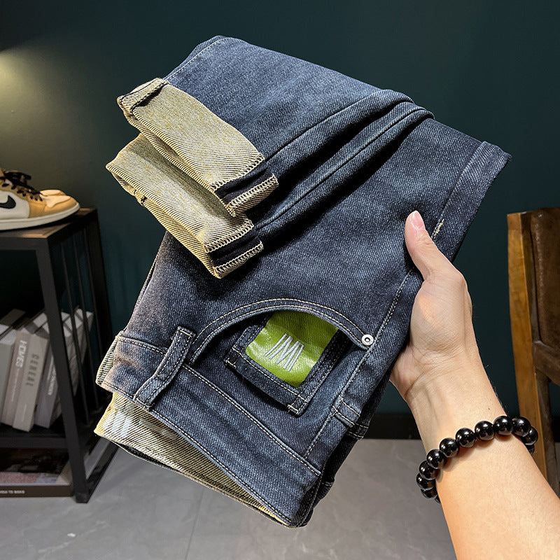Black and blue elastic straight-leg denim trousers with embroidered details