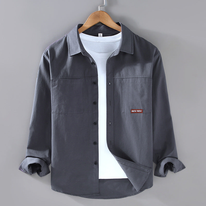 Beige long-sleeve cotton shirt with chest pockets and black buttons