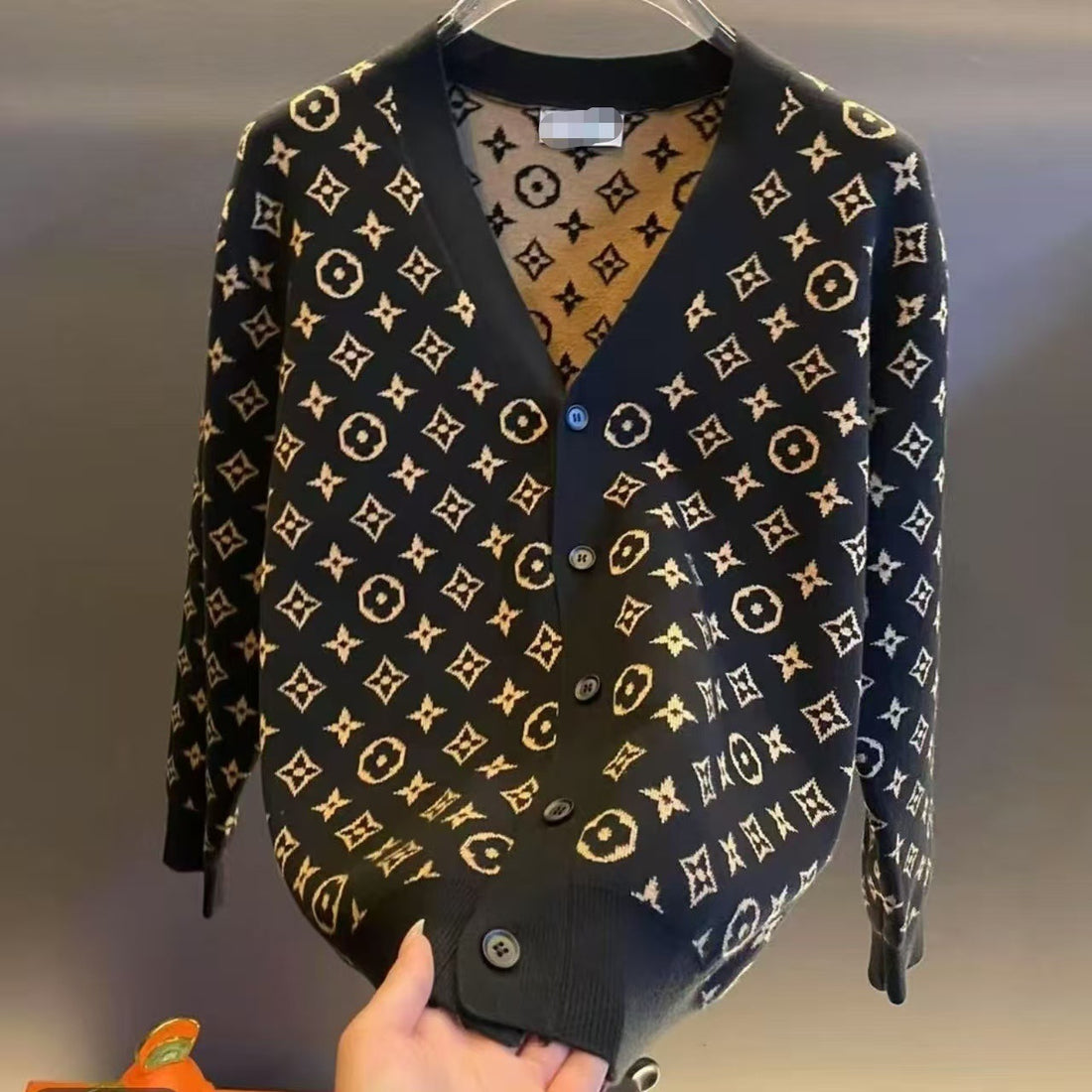 Black V-neck wool-blend sweater with tonal geometric pattern