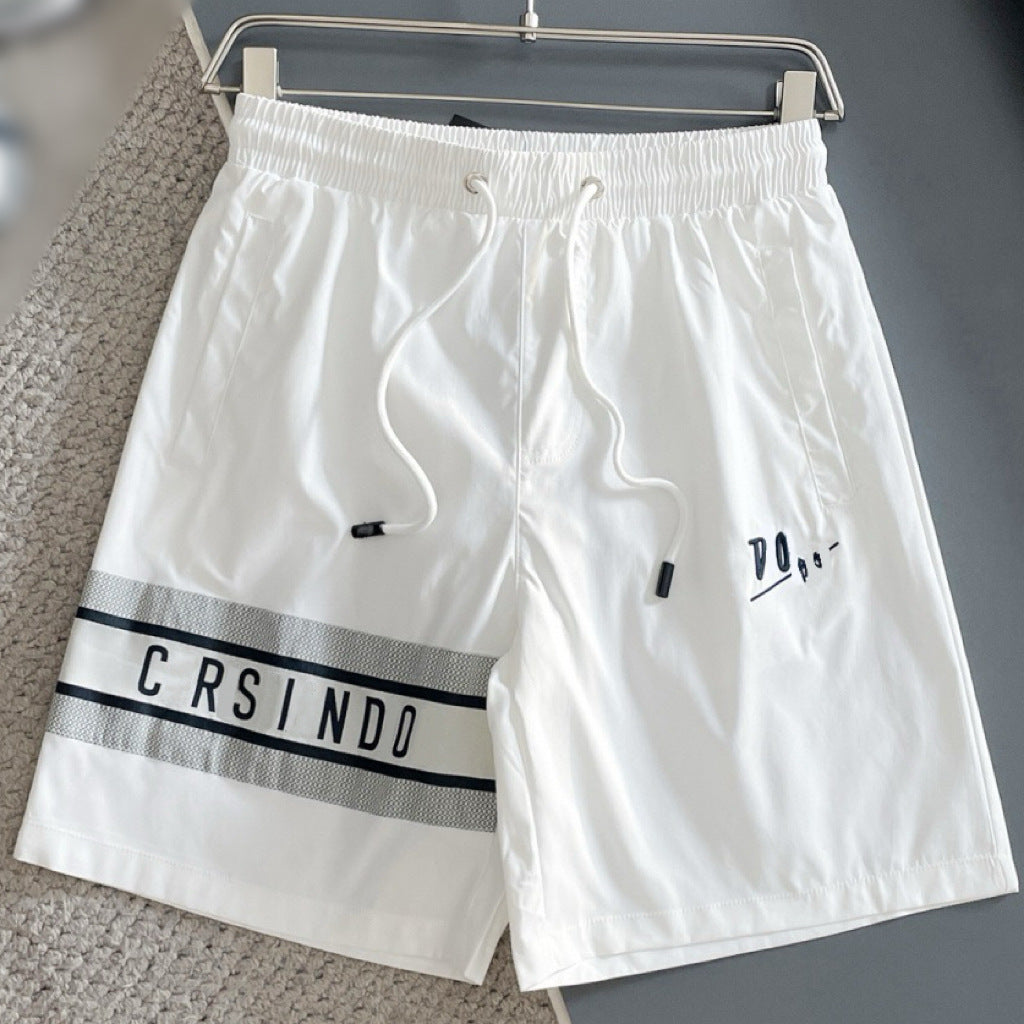 Black and white drawstring waist shorts with tonal lettering detail