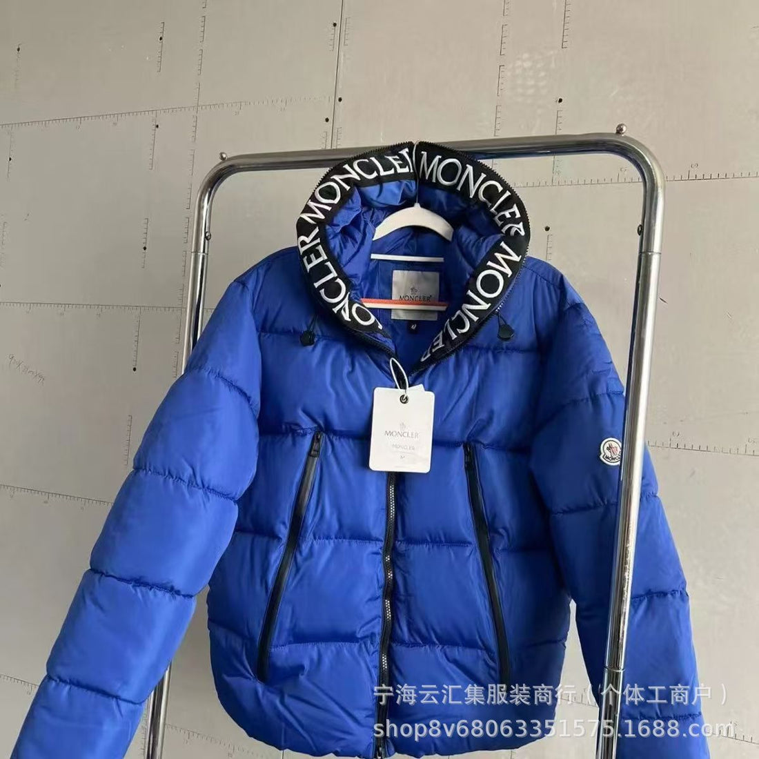 Black quilted down jacket with embroidered hood trim