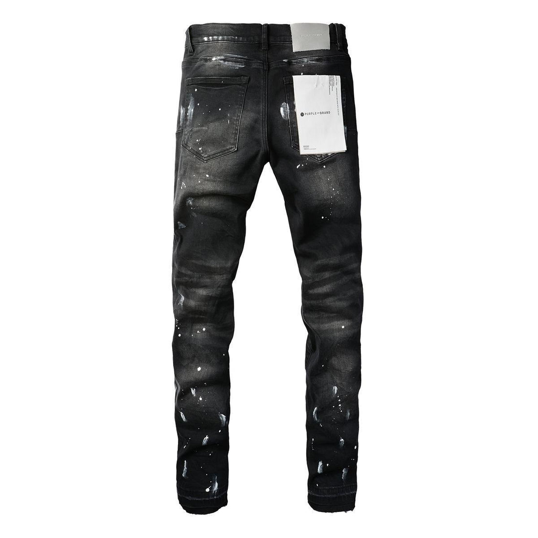 Black distressed jeans with paint splatter detail and ripped knees