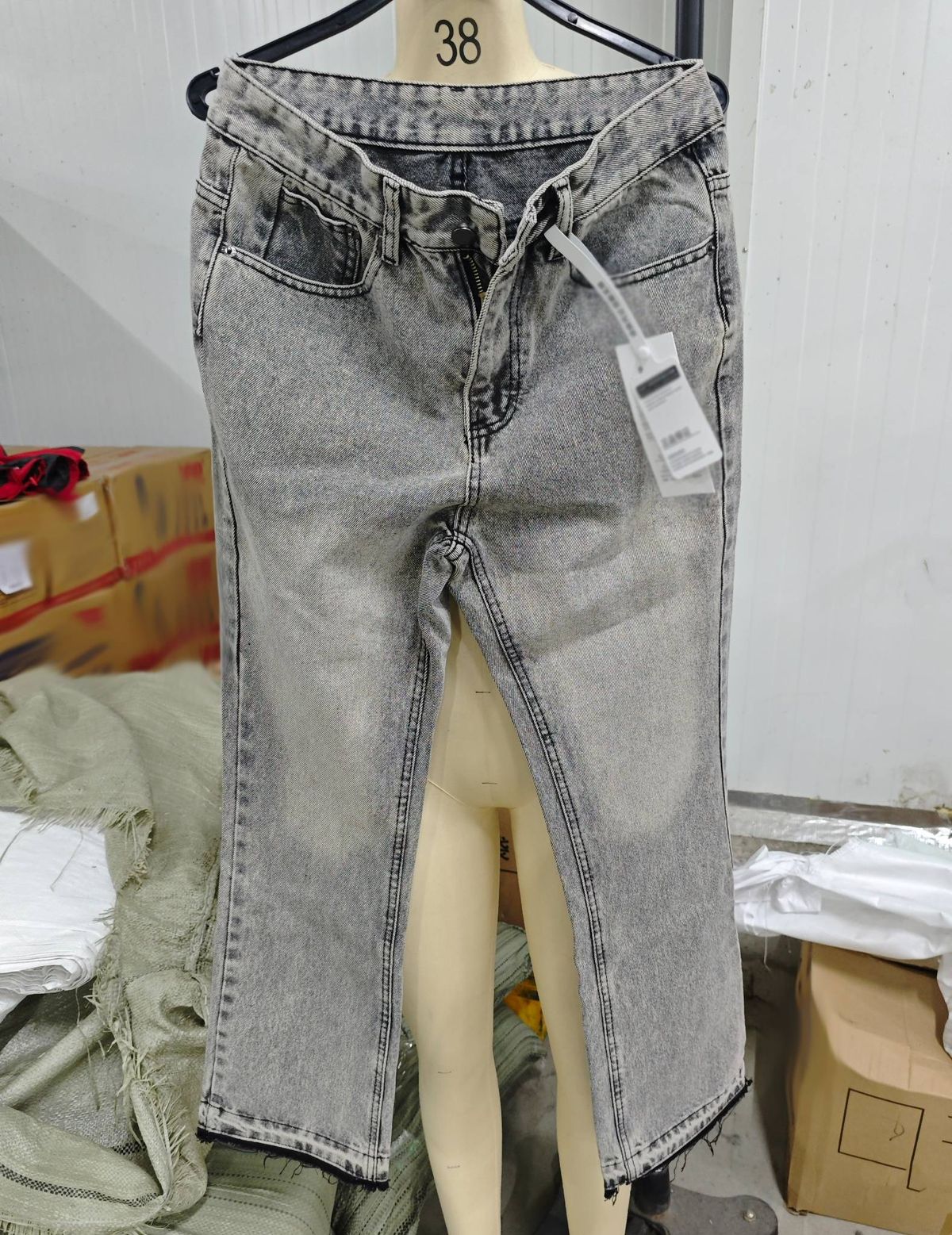 Distressed flared jeans with frayed hem and vintage grey wash